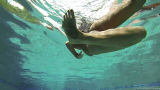 Busty August Ames dives in deep for an underwater tease