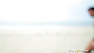 Bridgette B and Nicolette Shea play with each other on the beach