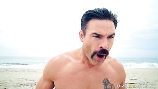 Bridgette B and Nicolette Shea play with each other on the beach